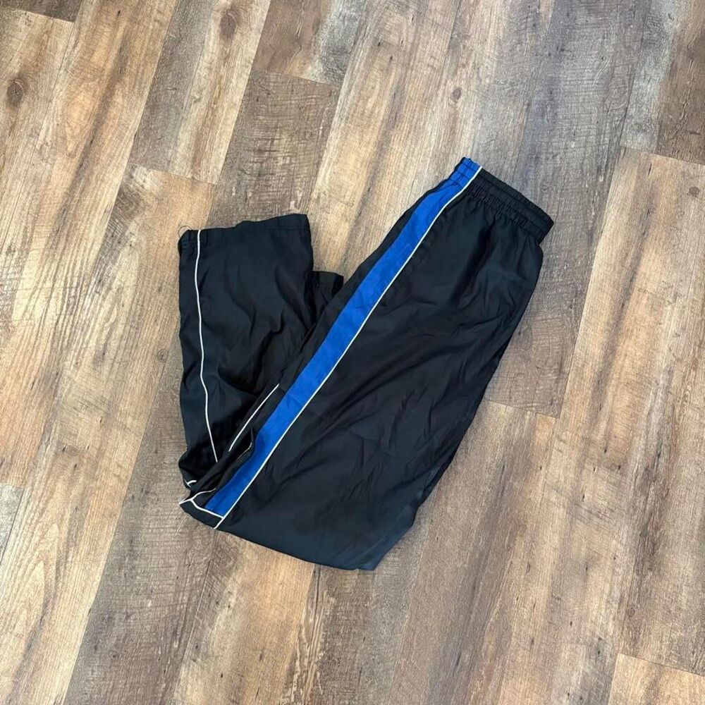 Mens Y2K 2000s Athletic Works black nylon track pants with blue and white stripe